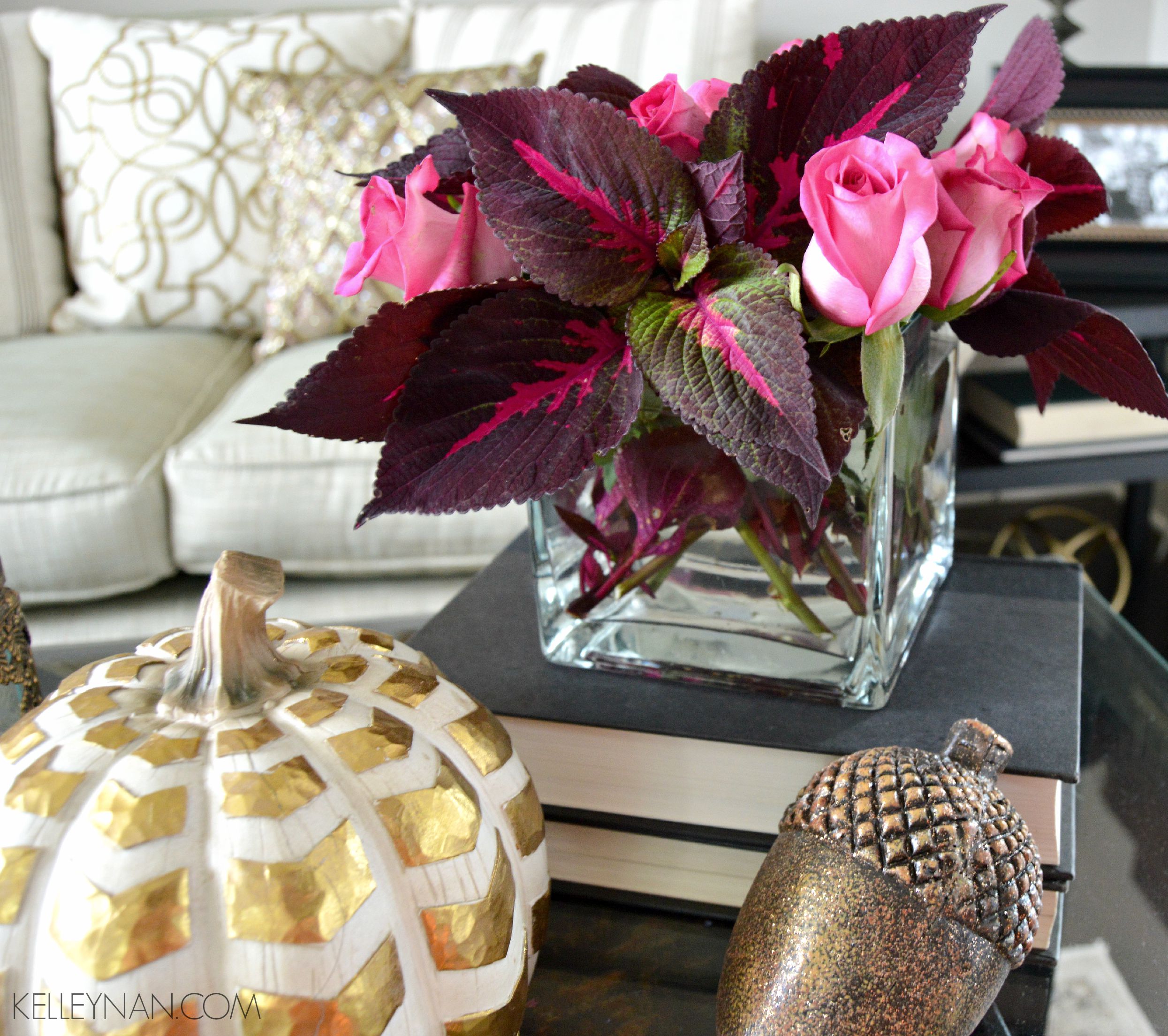 Red coleus and pink roses in formal living room with gold fall accessories