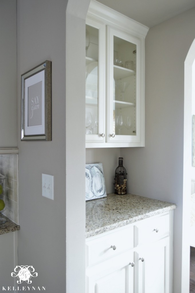 butler's pantery with glass doors and granite counter top