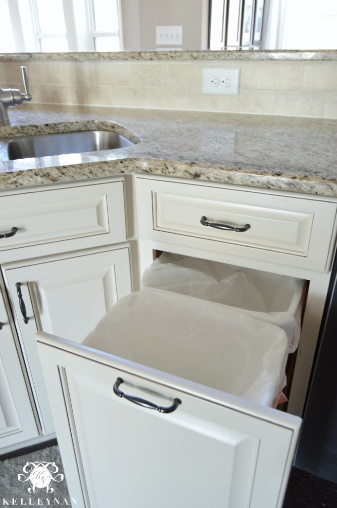 Pull out trash can in white cabinet