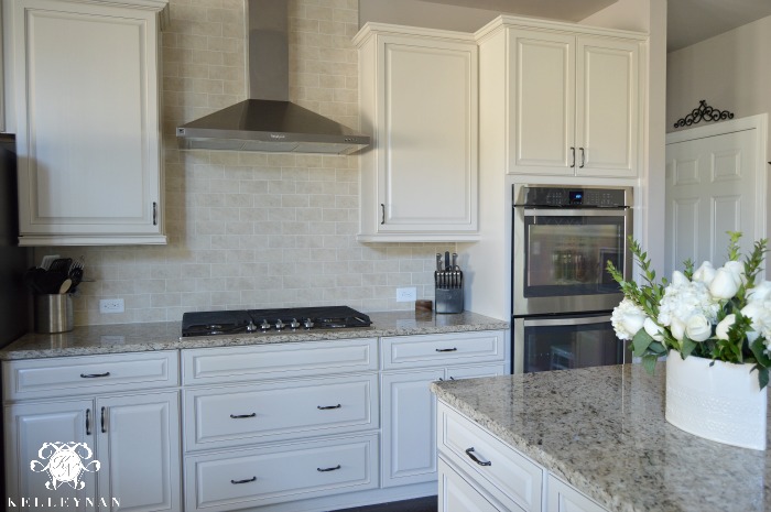 Neutral Kitchen White Cabinets and Stainless Steel Range Hood