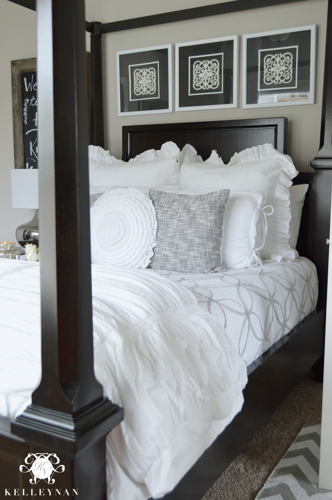 Black canopy bed with white bedding