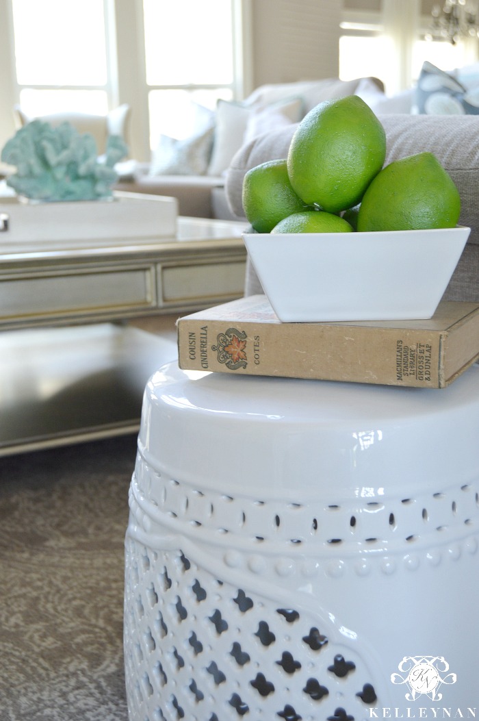 white garden stool with limes in living room