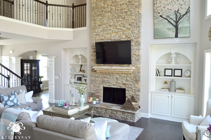 Two Story Living Room with stacked stone fireplace and built-ins