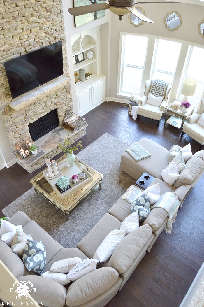 Two Story Living Room with stacked stone fireplace and built-ins Airy Elegant Living room