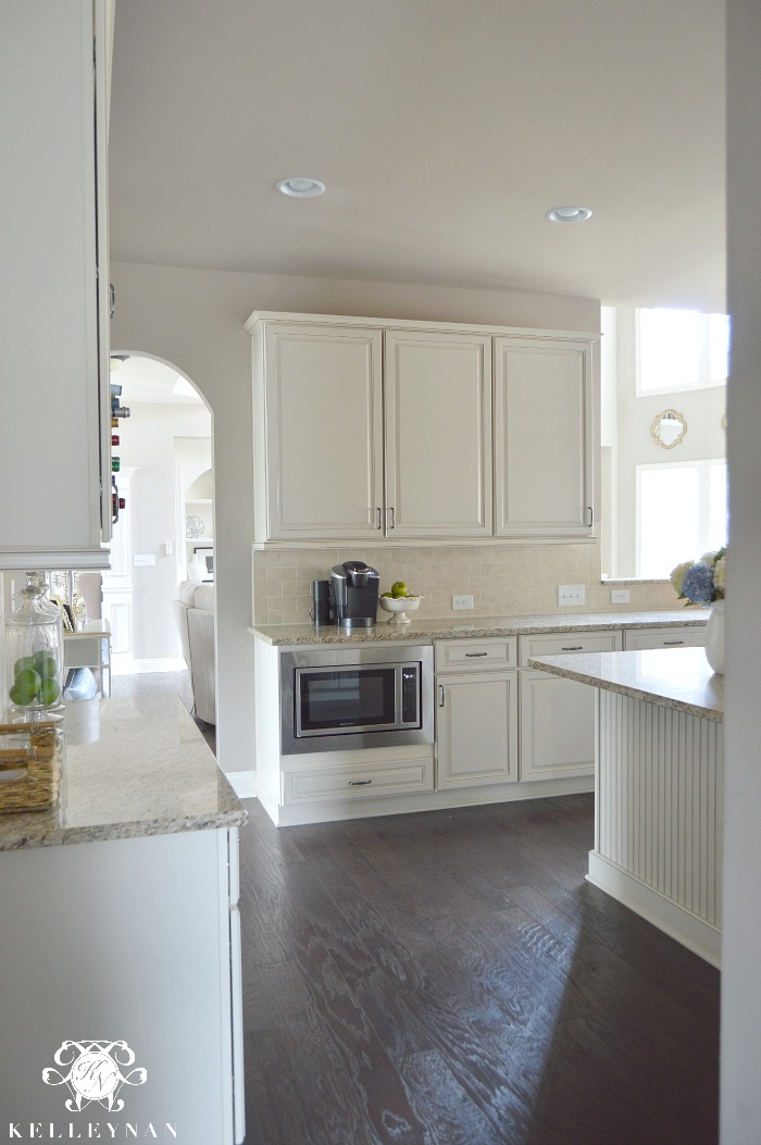 White Kitchen with Cream Cabinets and Dark Hardwood Floors