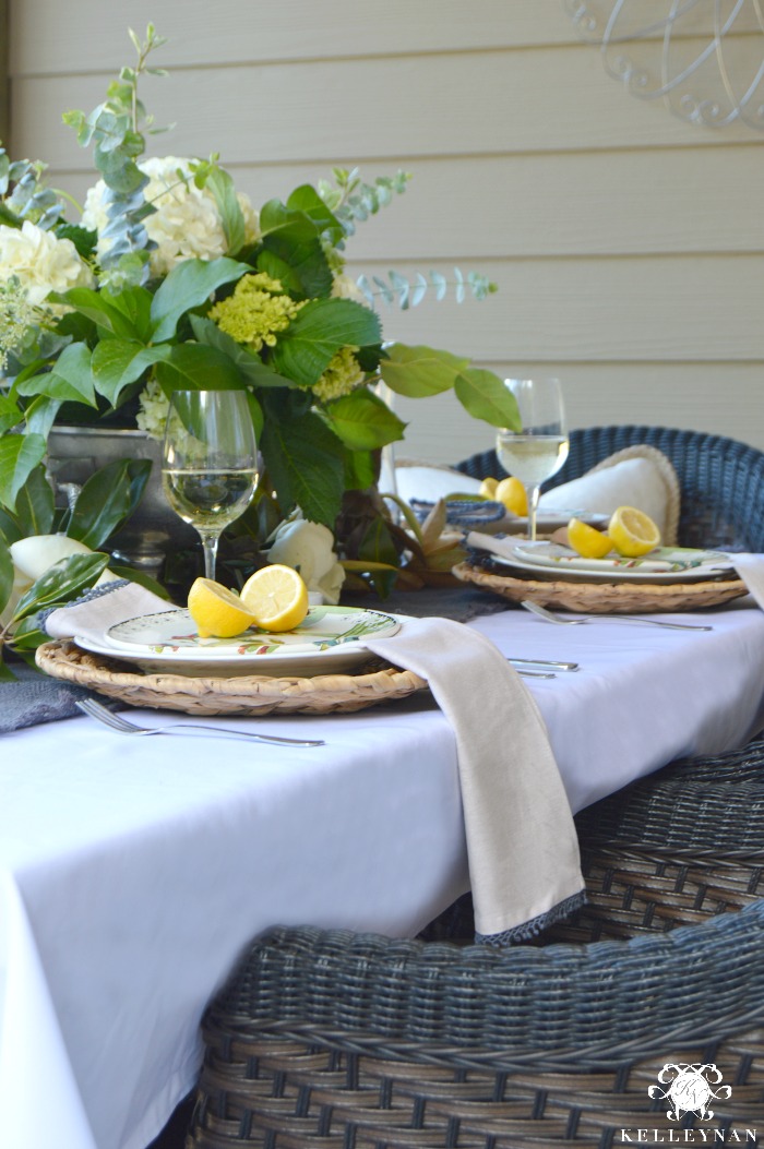 Outdoor Patio Dining Table With White Table Cloth and Hydrangeas