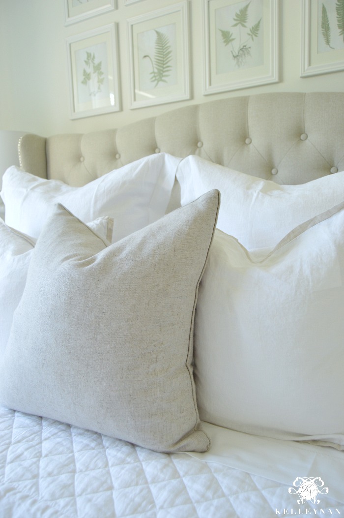 Pottery Barn Bedding with Gray tufted headboard and linen pillows