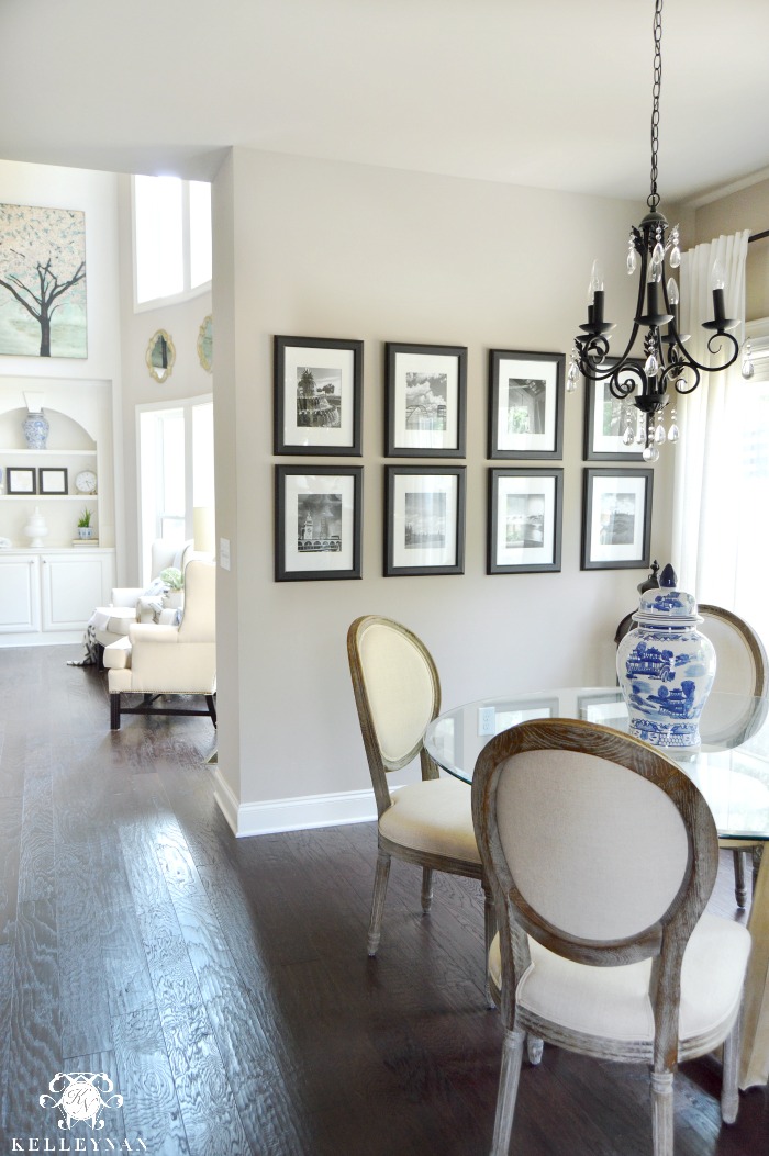 Black and White Travel Gallery Wall in Breakfast Nook with Round Back World Market Paige Chairs