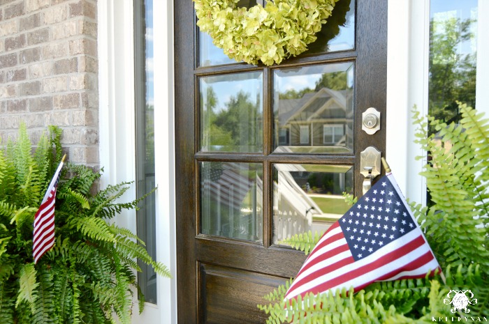 Flags in Ferns on Front Porch Flanking Front Door