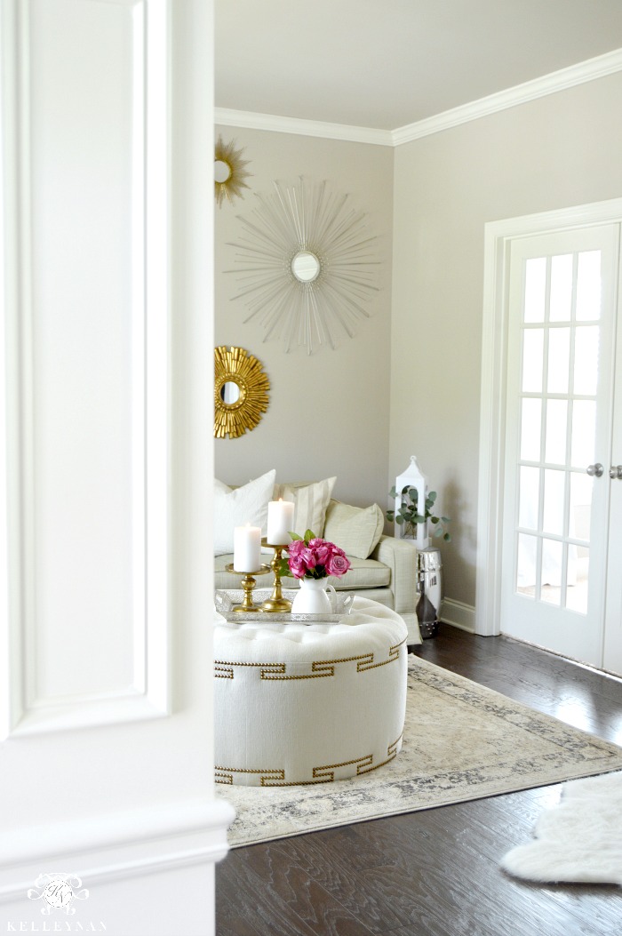 Formal Sitting Room with White Greek Key Ottoman and Gold accents