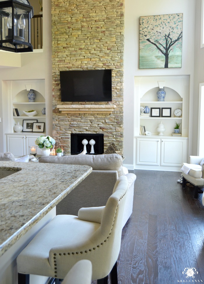 Two Story Great Room with Built Ins and Stone Fireplace
