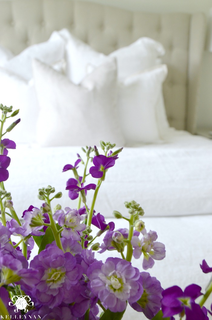 White bed with purple flowers