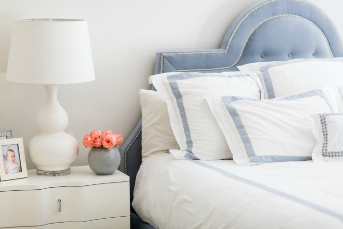 Blue tufted headboard and neutral master bedroom decor