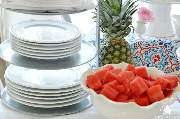 Watermelon Pineapple food display with plates on three tier tray