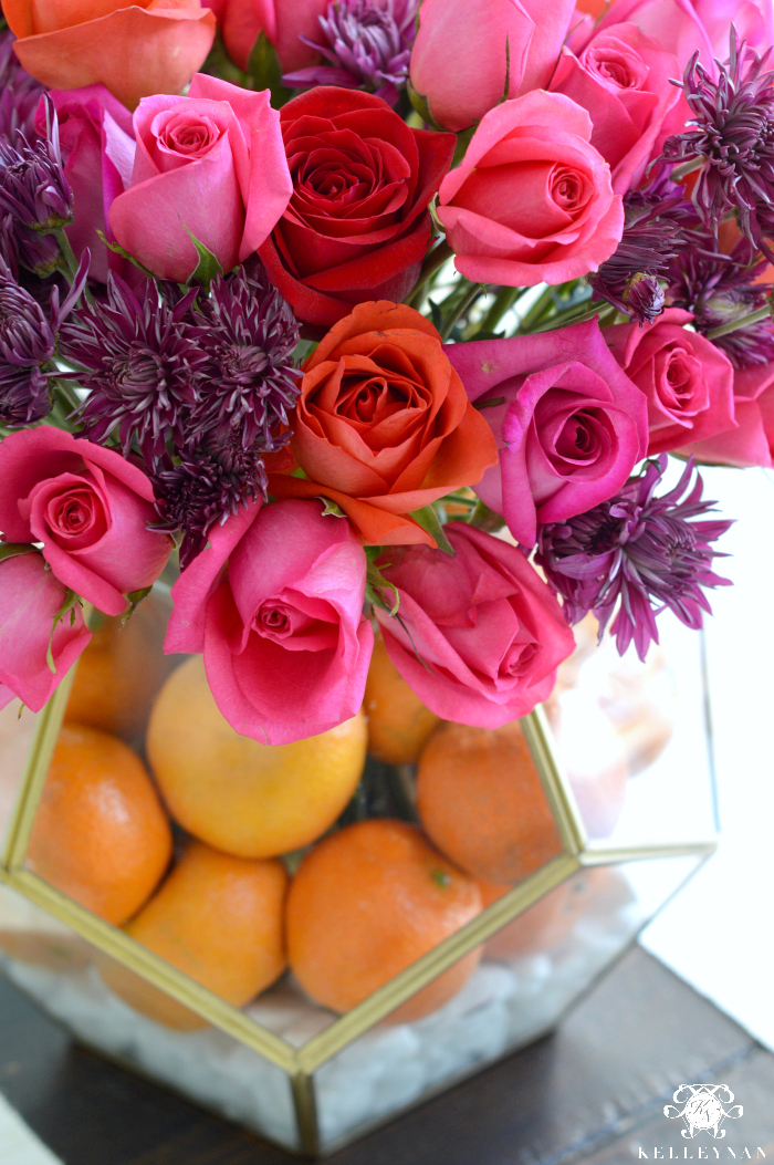 Jewel Tone Floral Arrangement With Orange Fruit in Gold Terrarium