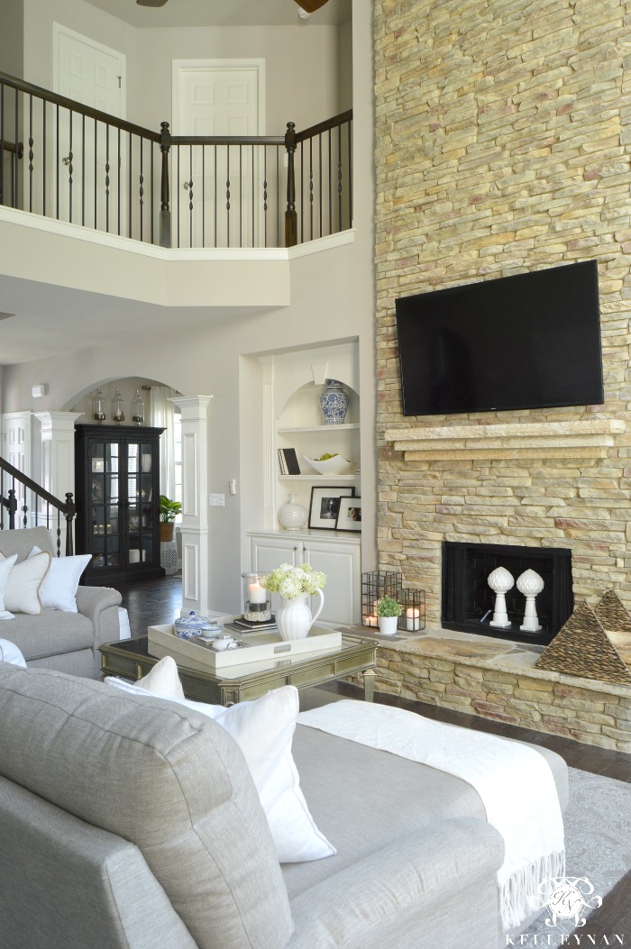 Two Story Great Living Room with Stacked Stone Fireplace and TV Above fireplace