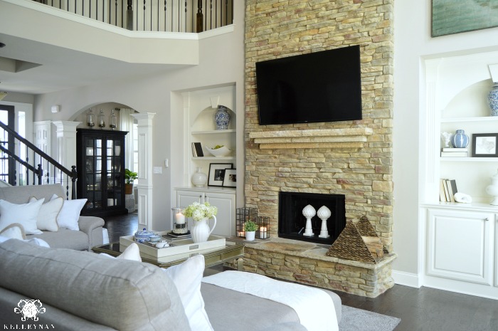 Two Story Living Room with Balcony Catwalk and Stacked Stone Fireplace and built-ins