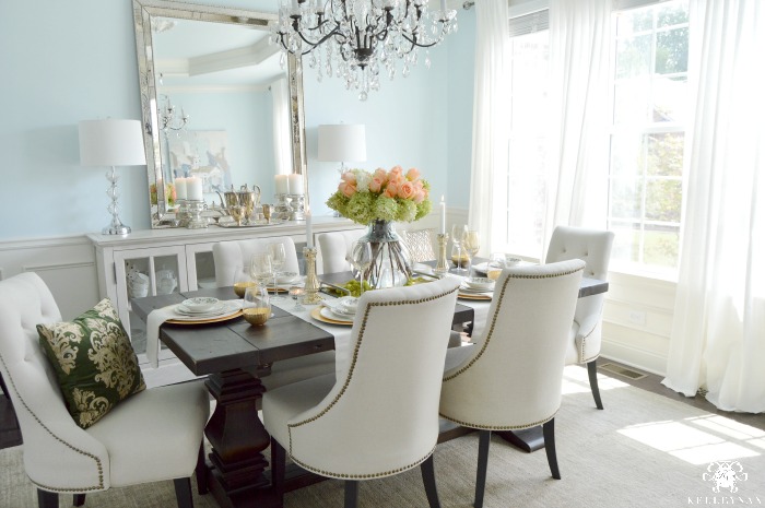 Elegant Blue Dining Room with Crystal Chandelier and White Curtains