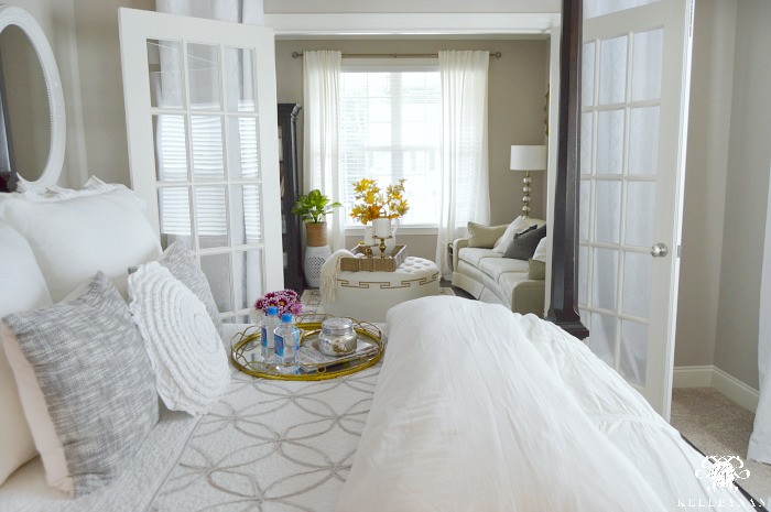 white-guest-bedroom-looking-into-living-room-through-french-doors