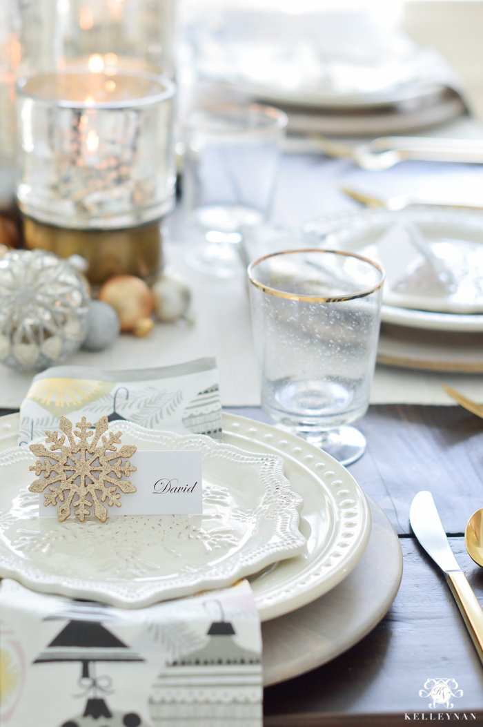 silver-and-gold-world-market-holiday-christmas-tablescape-ideas-with-snowflakes-and-hurricanes-with-candles-1-of-18