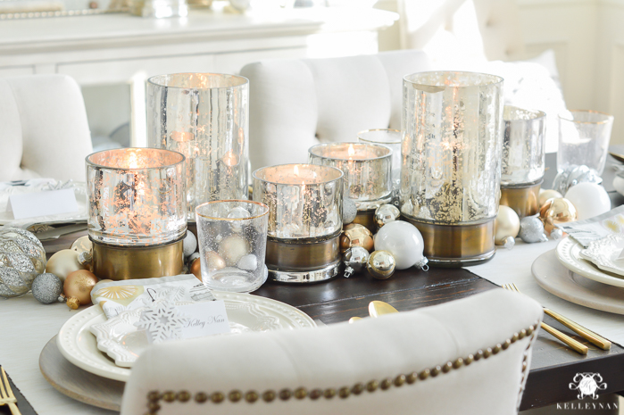 silver-and-gold-world-market-holiday-christmas-tablescape-ideas-with-snowflakes-and-hurricanes-with-candles-17-of-18