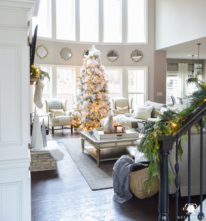 elegant-two-story-great-room-with-christmas-tree-in-front-of-windows