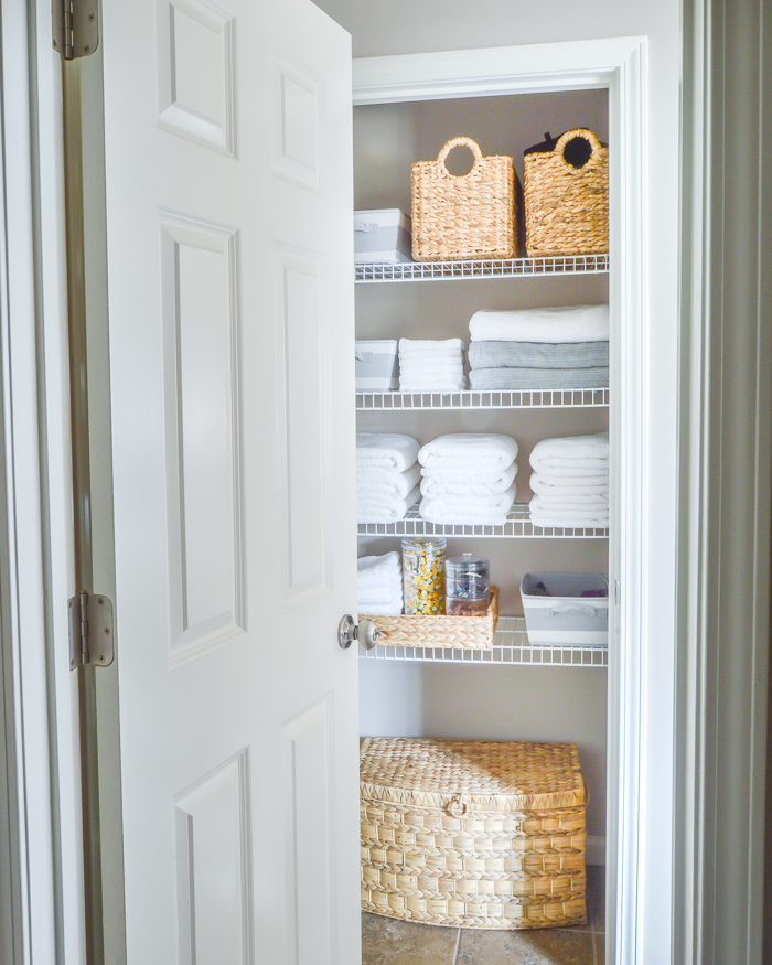 https://kelleynan.com/wp-content/uploads/2017/03/Organized-bathroom-linen-closet-with-baskets-and-white-towels.jpg