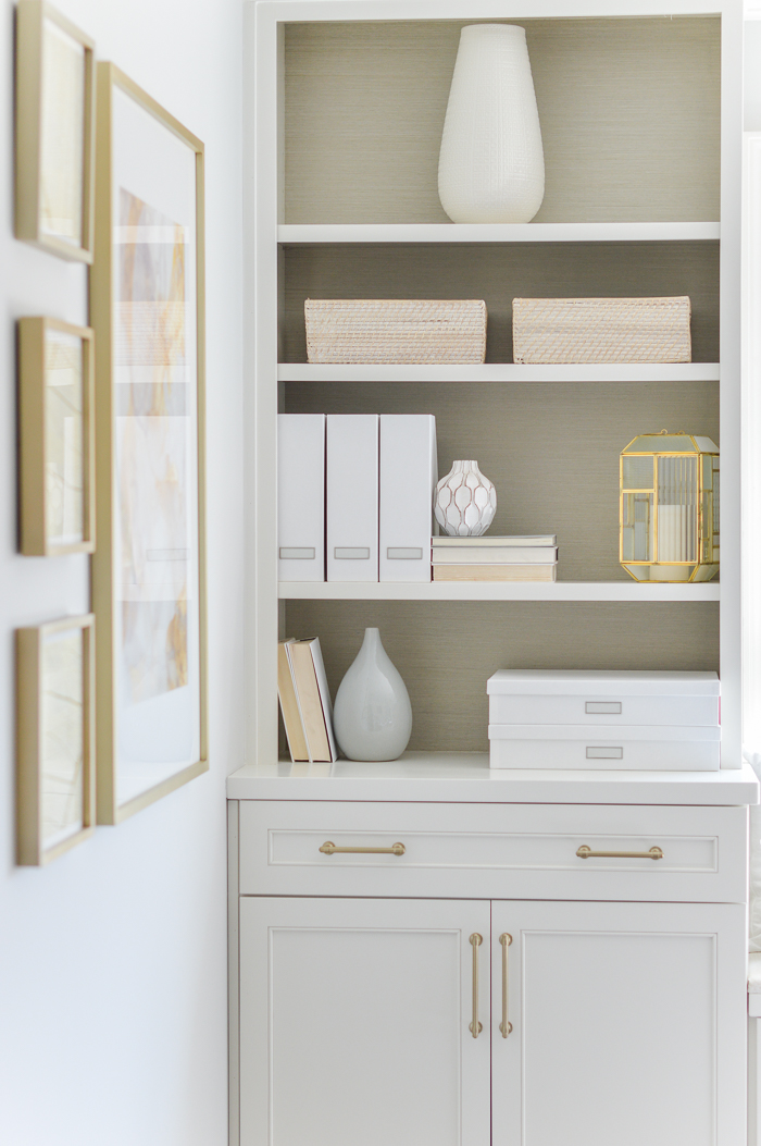 Organized office built in shelves with baskets and grass cloth