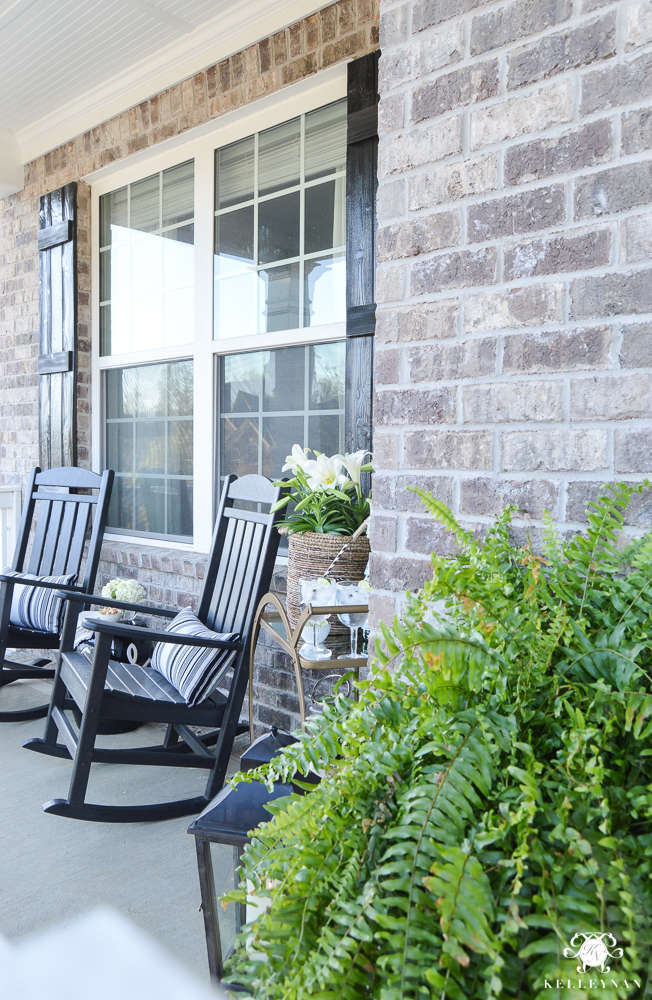 Spring Decorated Rocking Chair Front Porch with a Gold Bar Cart with polywood rockers