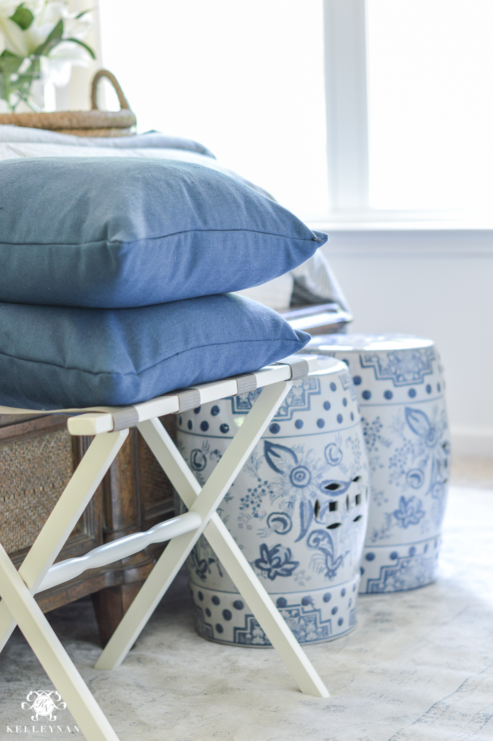 One Room Challenge Blue and White Guest Bedroom Reveal Before and After Makeover- luggage rack and garden stools at the foot of the bed