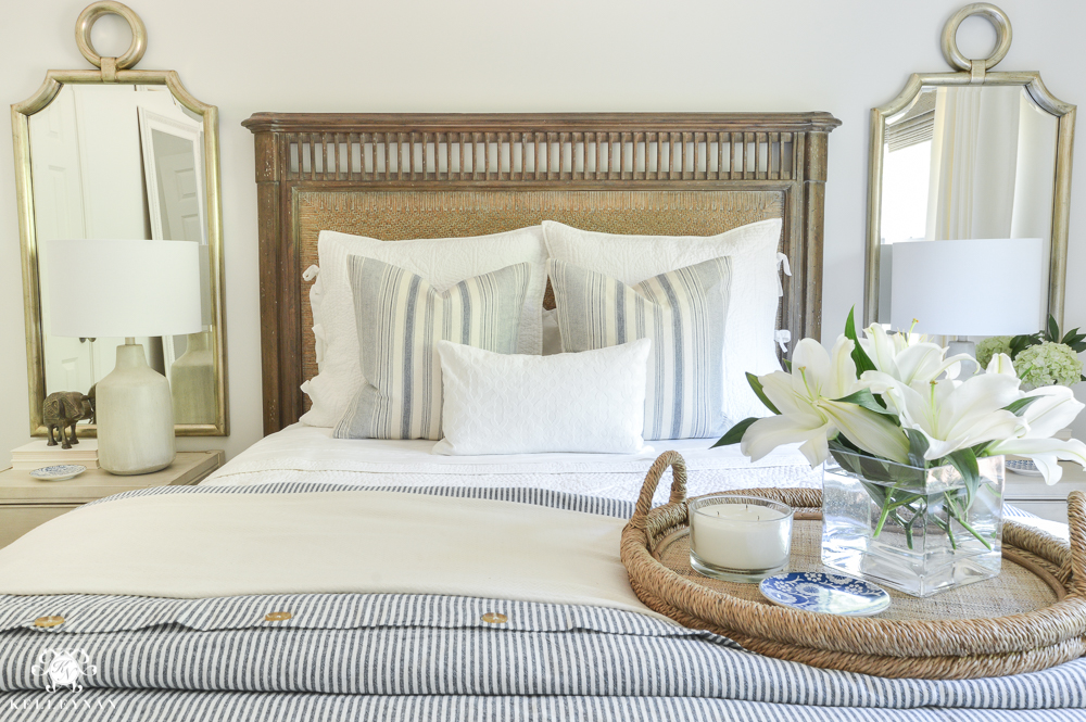 One Room Challenge Blue and White Guest Bedroom Reveal Before and After Makeover- wooden bed and woven tray with mirrors on either side of bed