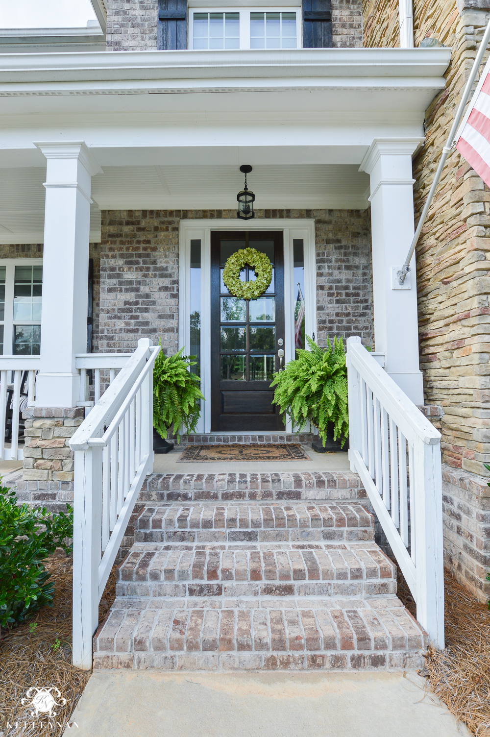 Shades of Summer Home Tour with Neutrals and Naturals- craftsman style home with brick and stacked stone and ferns on either side of door