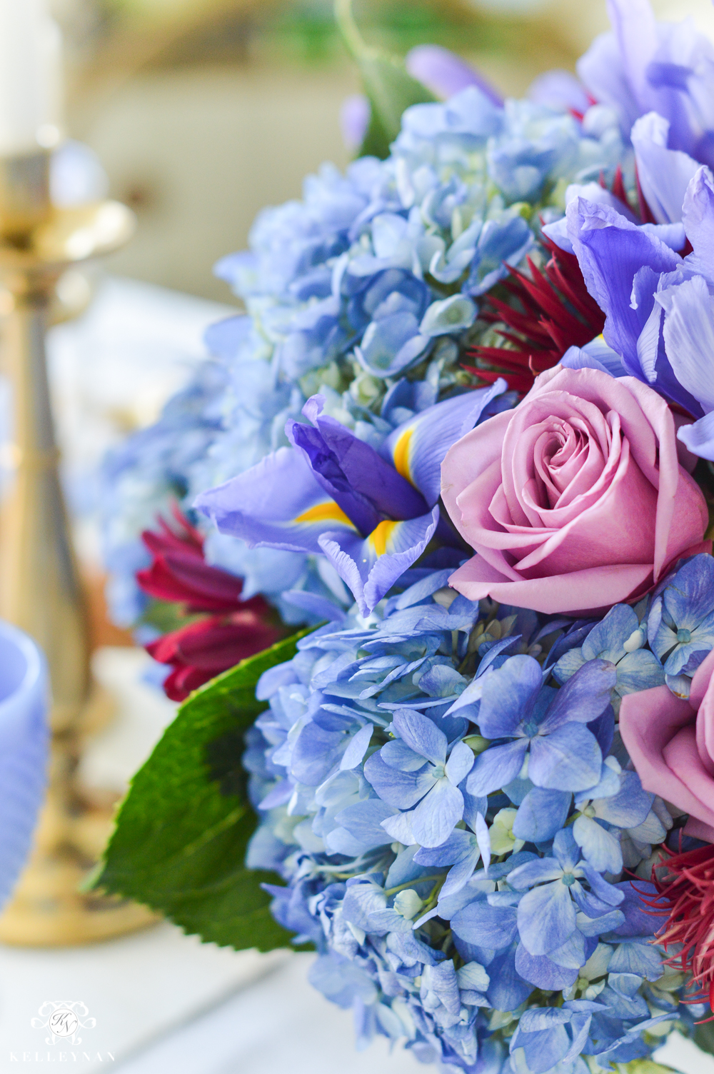 blue hydrangea and purple rose flower arrangement