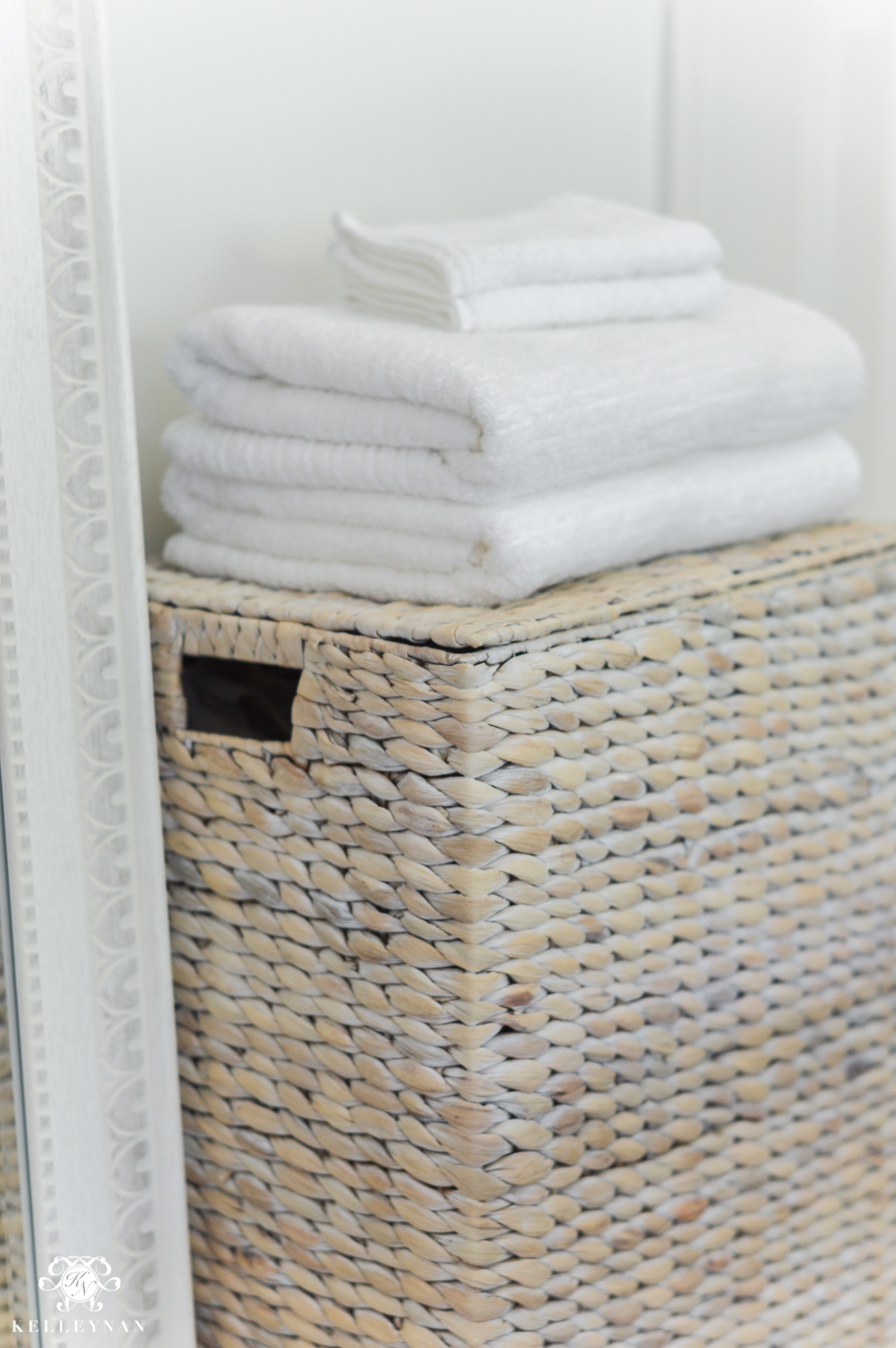 Guest Room Essentials- What every guest bedroom should have- woven hamper with white towels