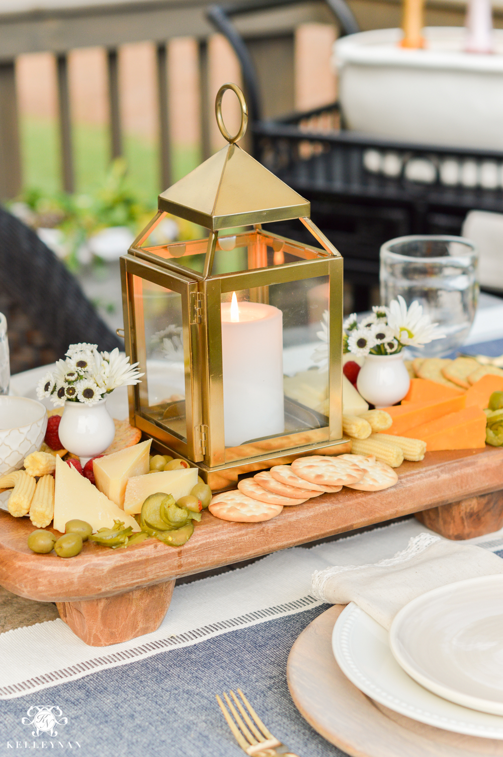 Outdoor Entertaining and Table Ideas with Cheese board appetizer centerpieces- cheese board with gold lanterns