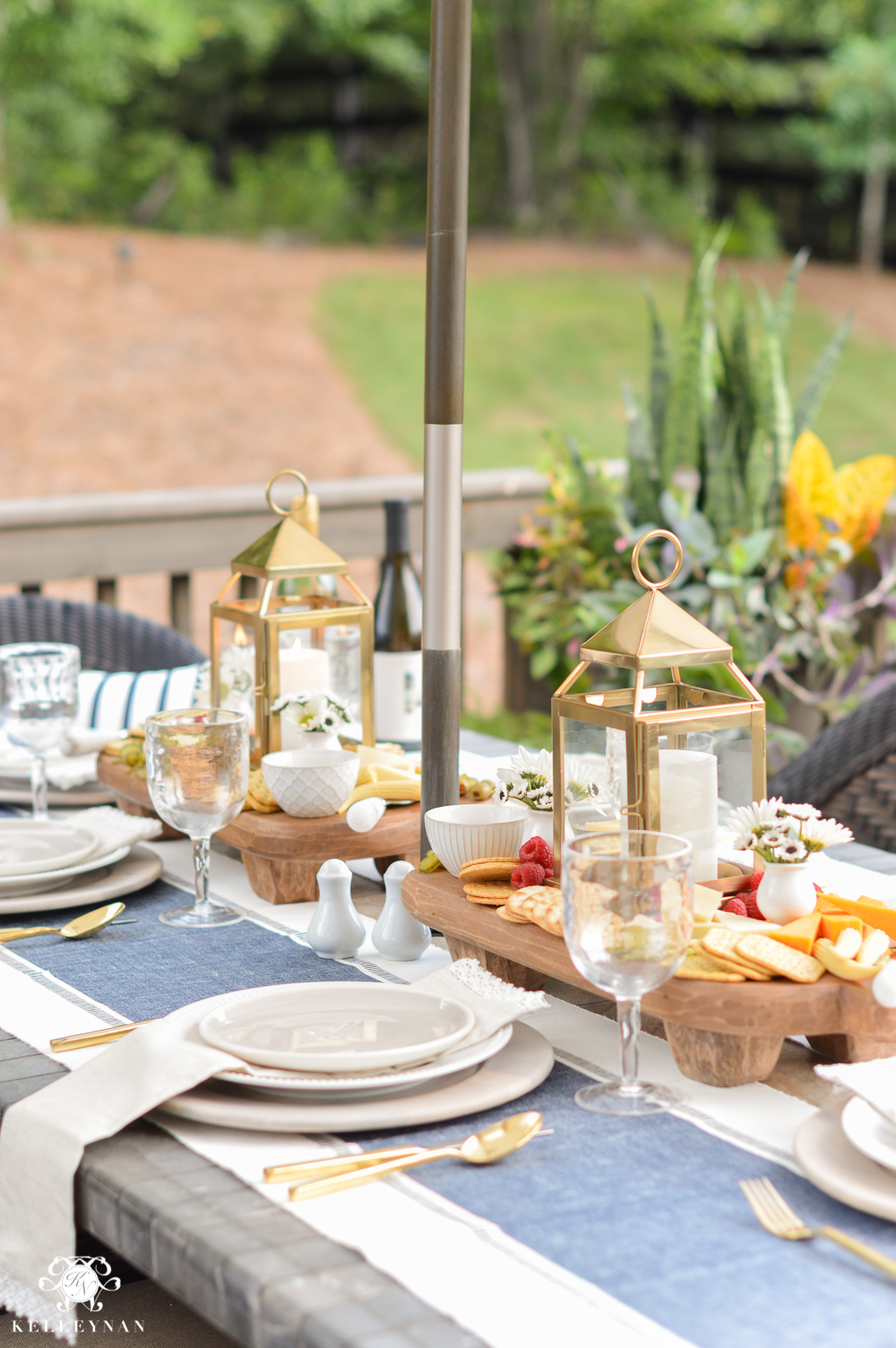 Outdoor Entertaining and Table Ideas with Cheese board appetizer centerpieces- with gold pottery barn lanterns