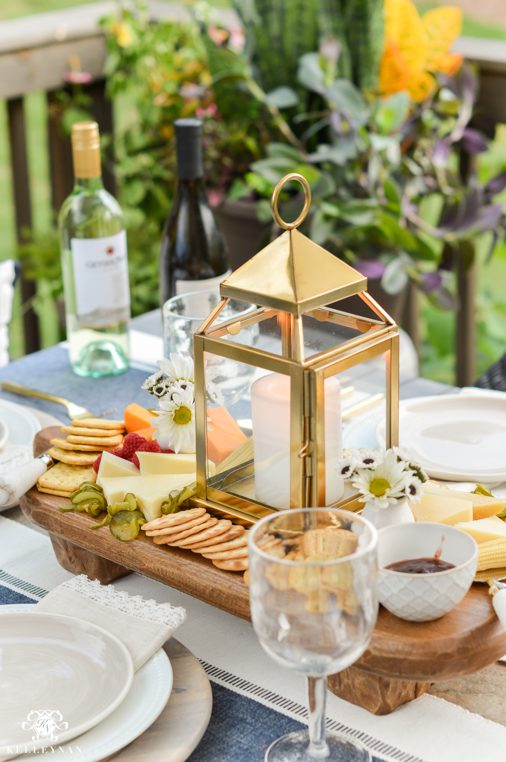 Outdoor Entertaining and Table Ideas with Cheese board appetizer centerpieces- wooden board with lanterns