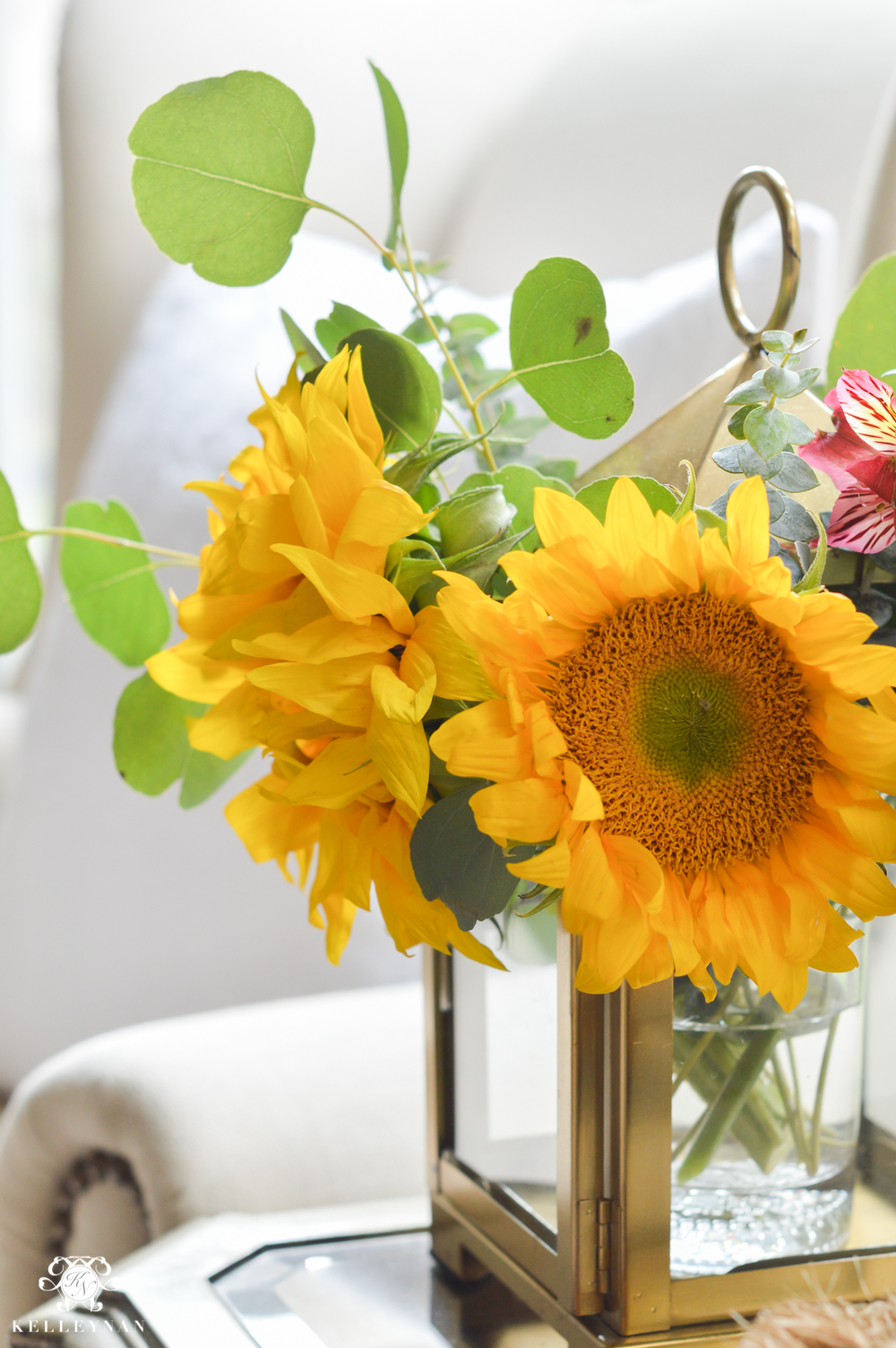 Floral Arrangement in Lantern- sunflowers and eucalyptus in small gold lantern