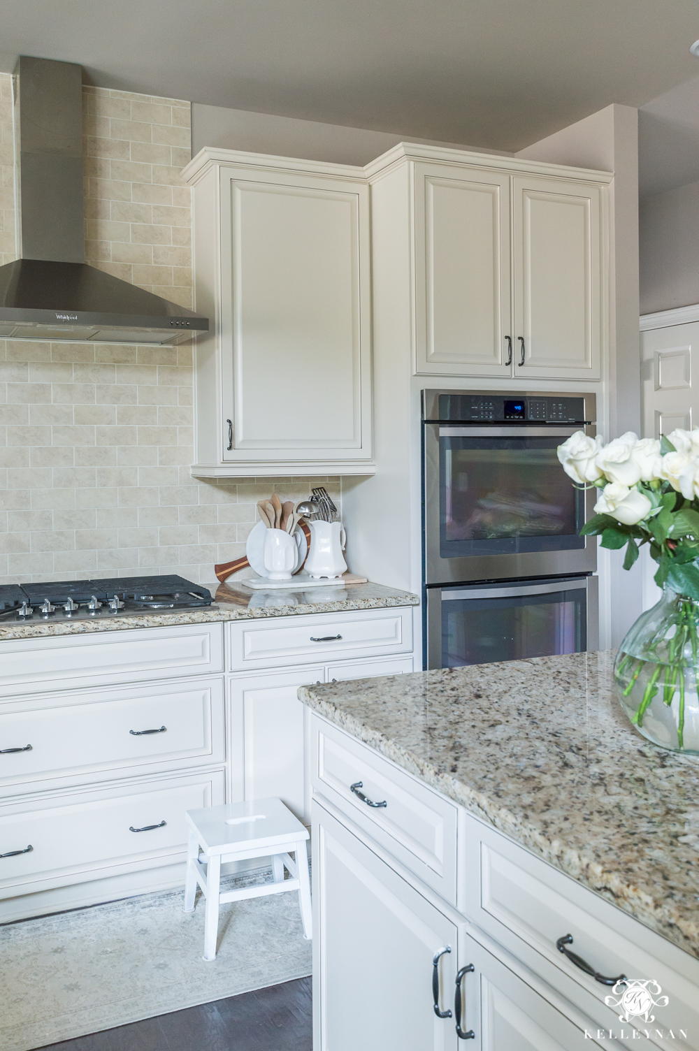 Organized Spice and Baking Cabinet- Kitchen Organization- neutral kitchen with white roses on island