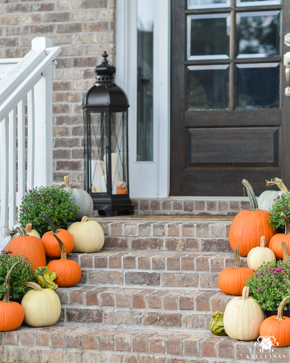 2017 Fall Home Tour with Yellow and Orange Leaves- pumpkins on front porch steps with lanterns