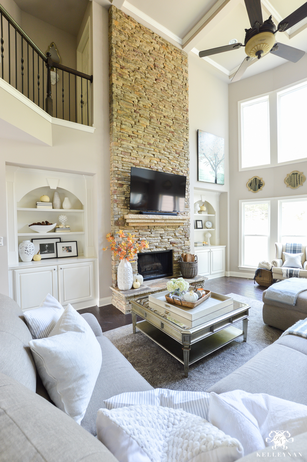 2017 Fall Home Tour with Yellow and Orange Leaves- two story living room with stacked stone fireplace