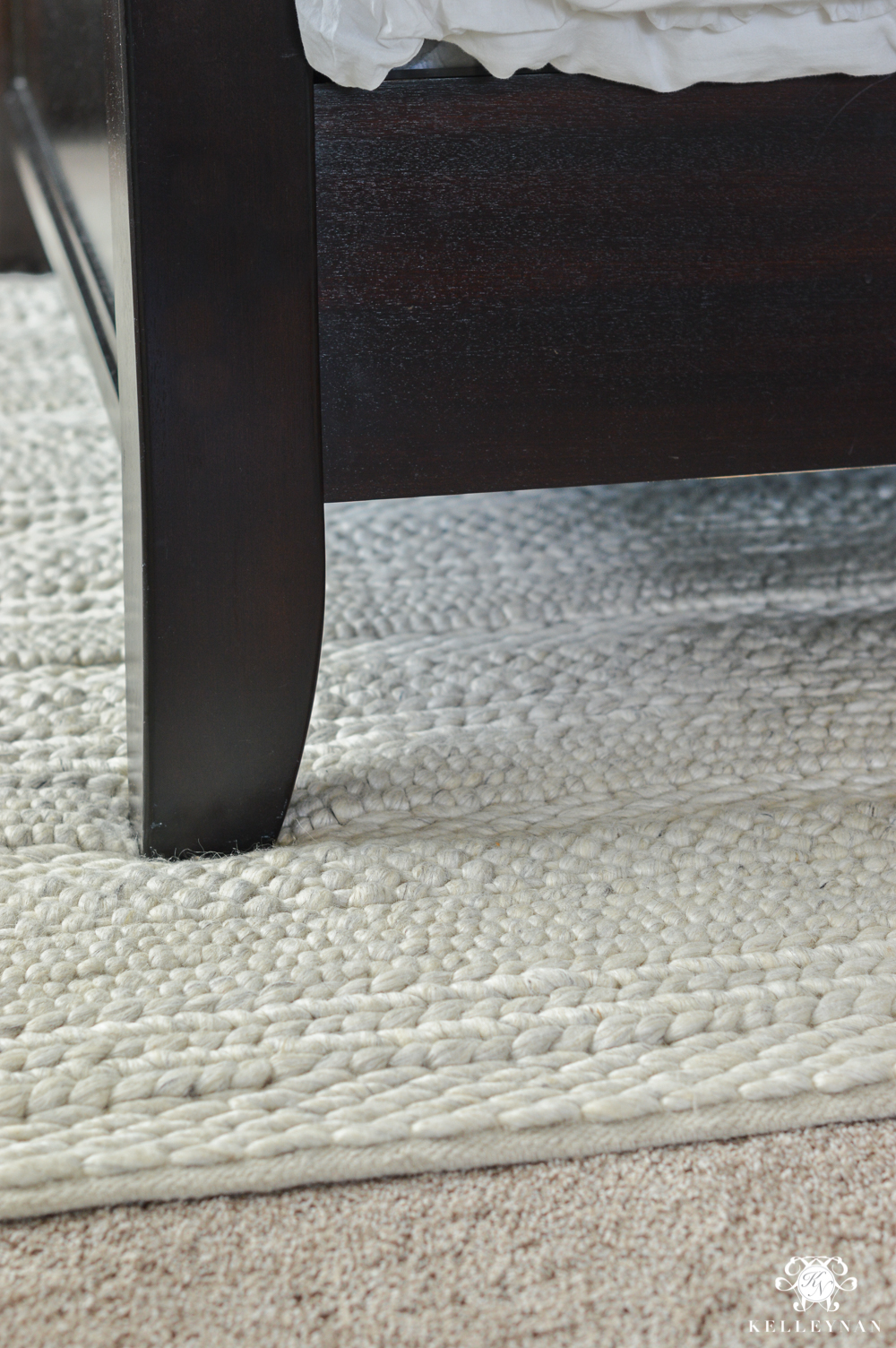 Why Rugs Should Be Layered On Carpet- chunky knit wool rug under bed