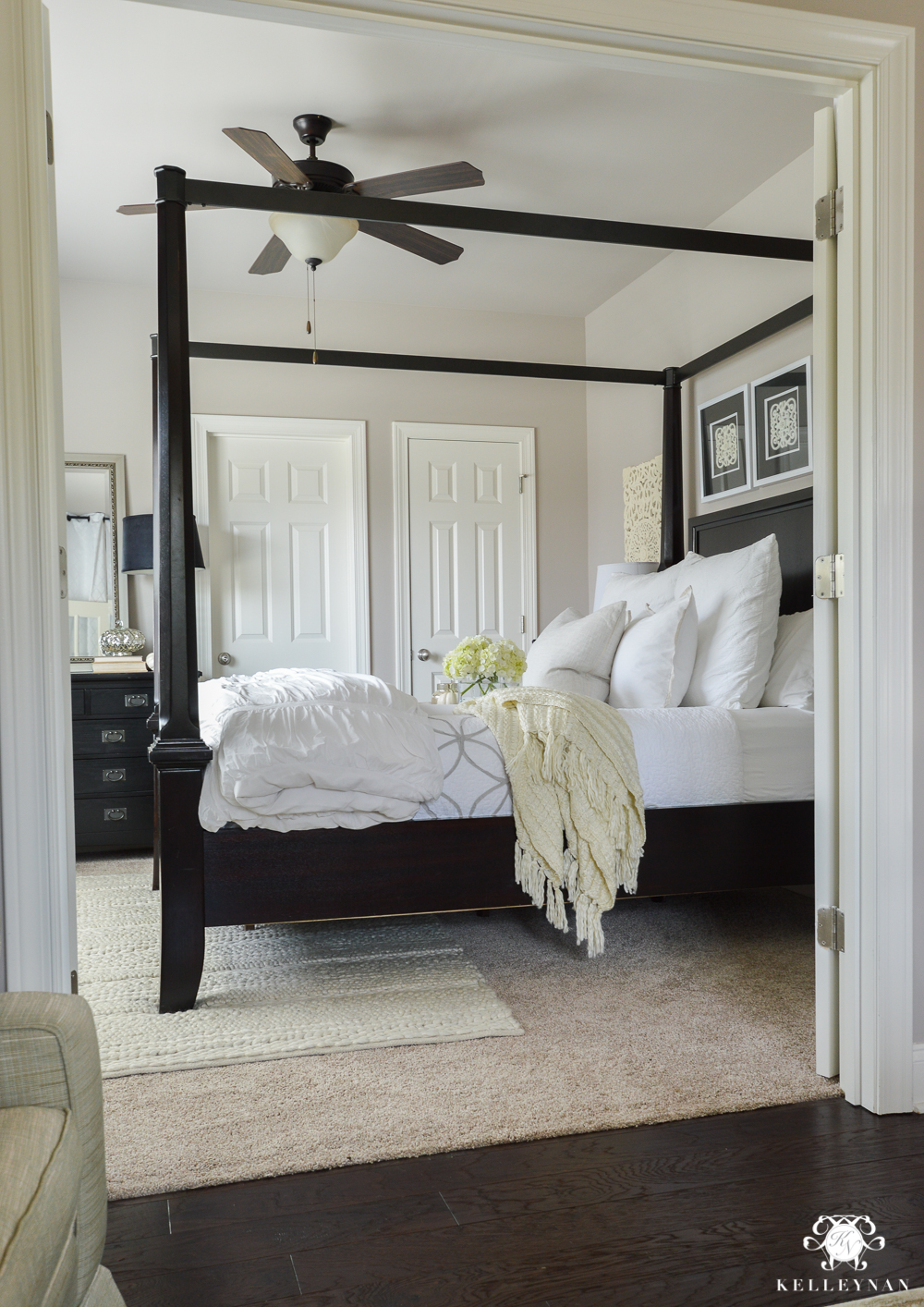 Why Rugs Should Be Layered On Carpet- guest bedroom with canopy bed