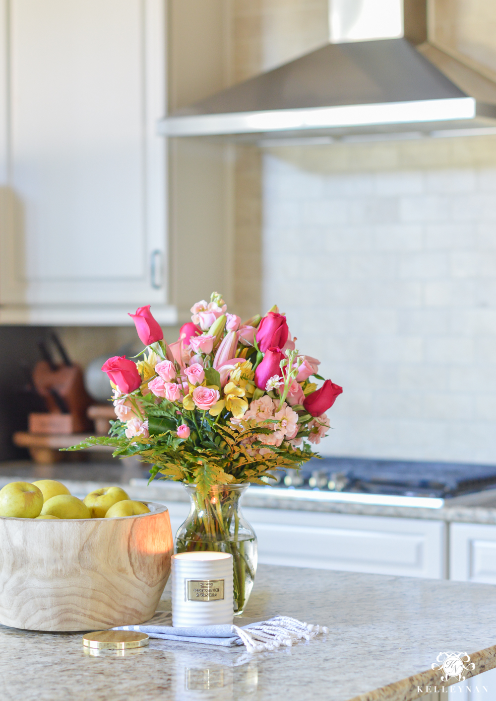 Kitchen island flowers with basket of apples