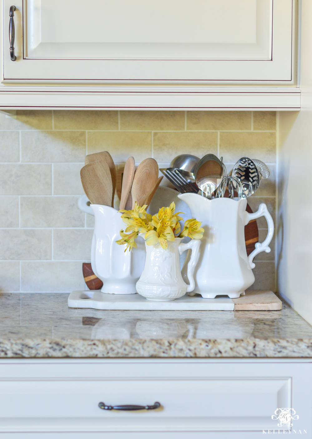 Flowers in a pitcher on a cutting board