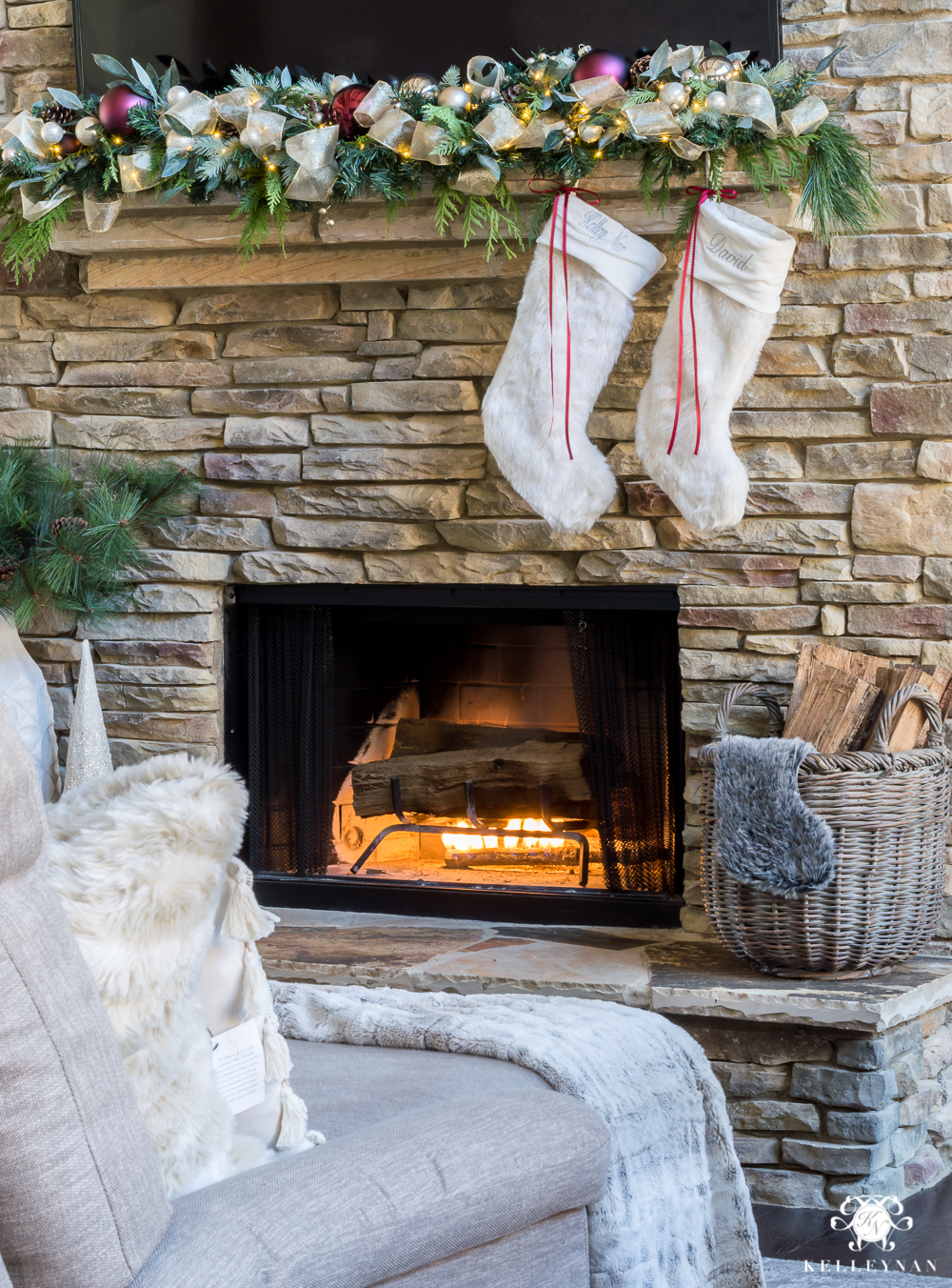 fur stocking ideas hung on a stacked stone fireplace