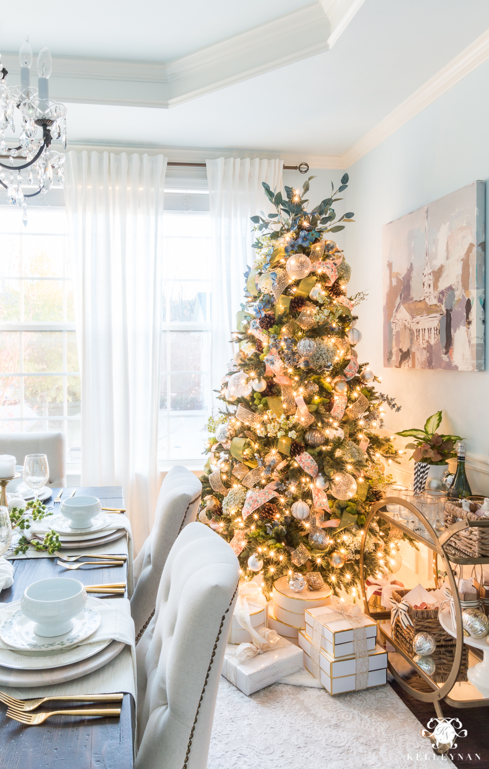 Dining room Christmas tree with bar cart of gifts