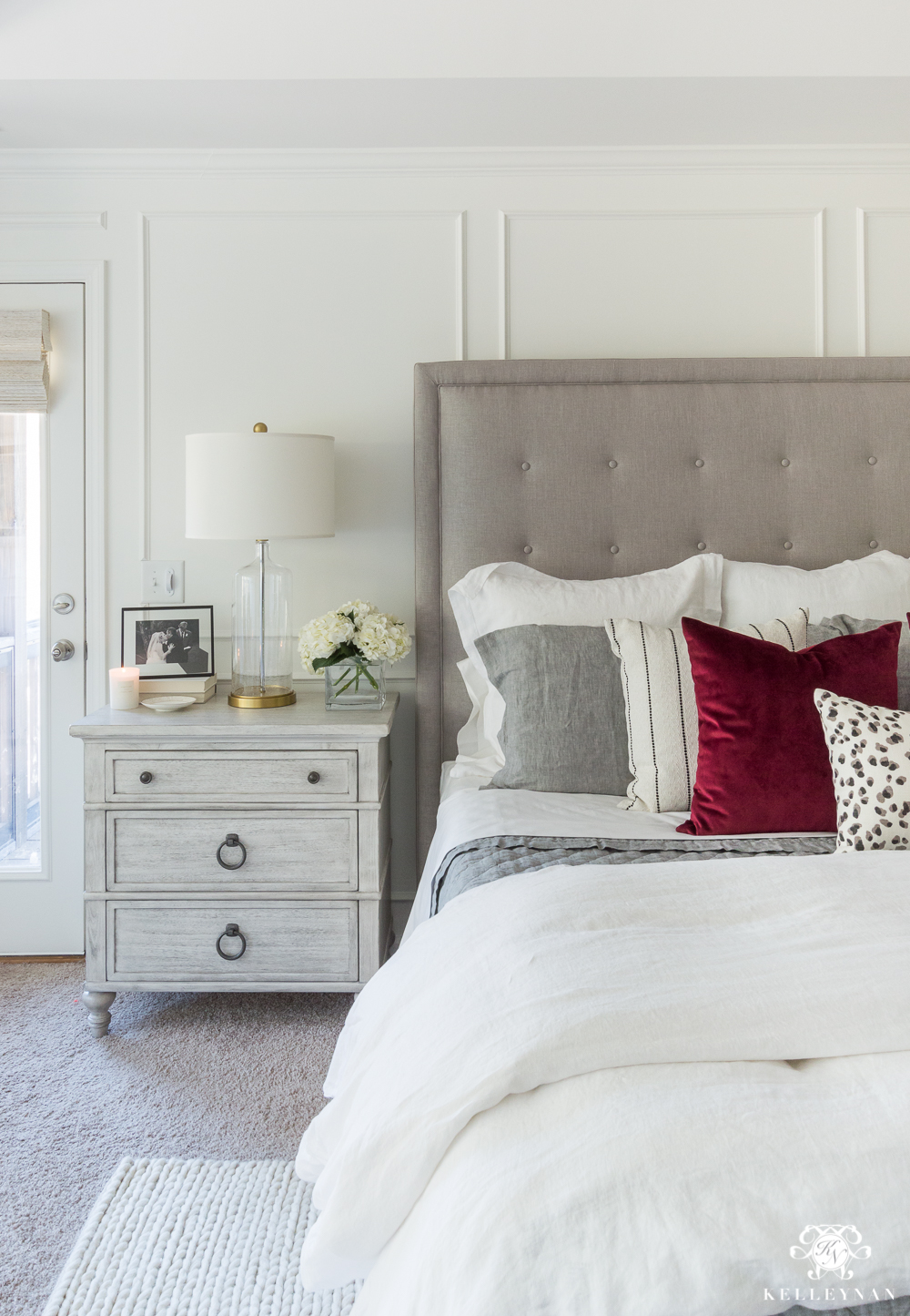 Neutral master bedroom with a pop of red 