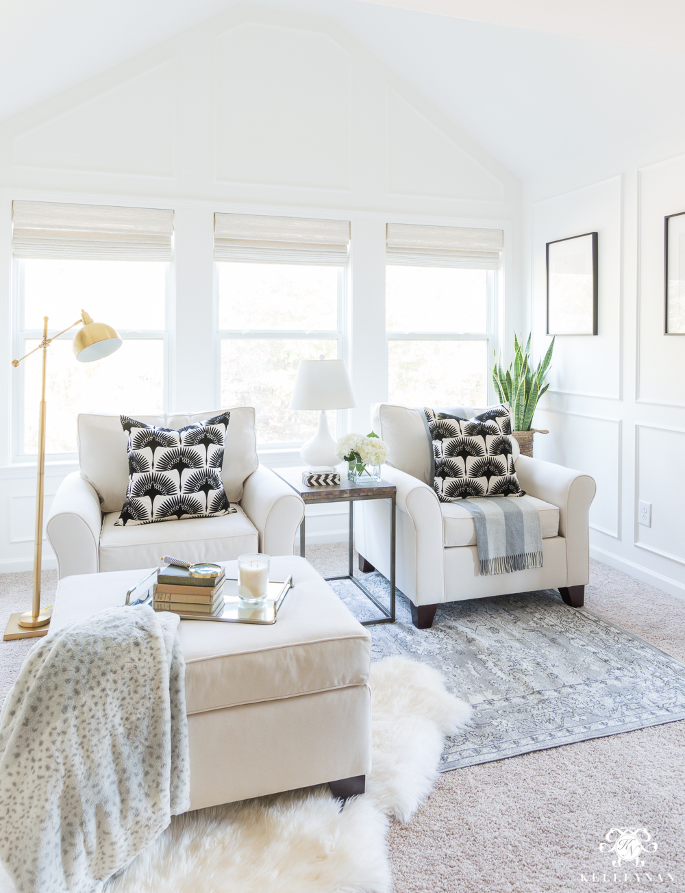 Transitional modern bedroom sitting nook with white chairs