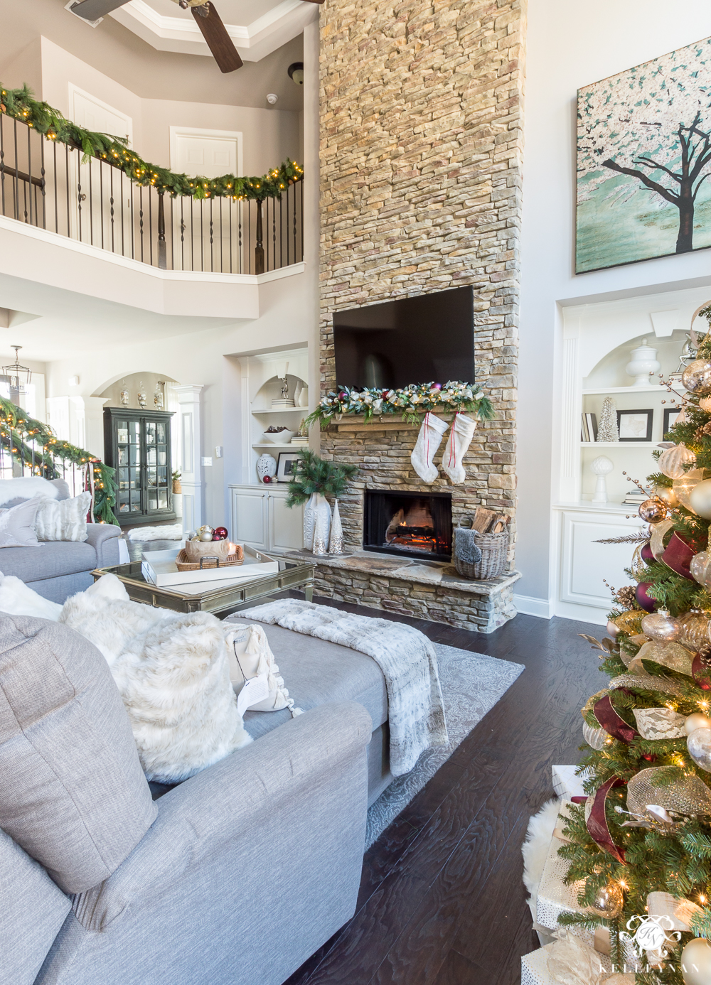 Tall Stacked stone fireplace decorated for Christmas